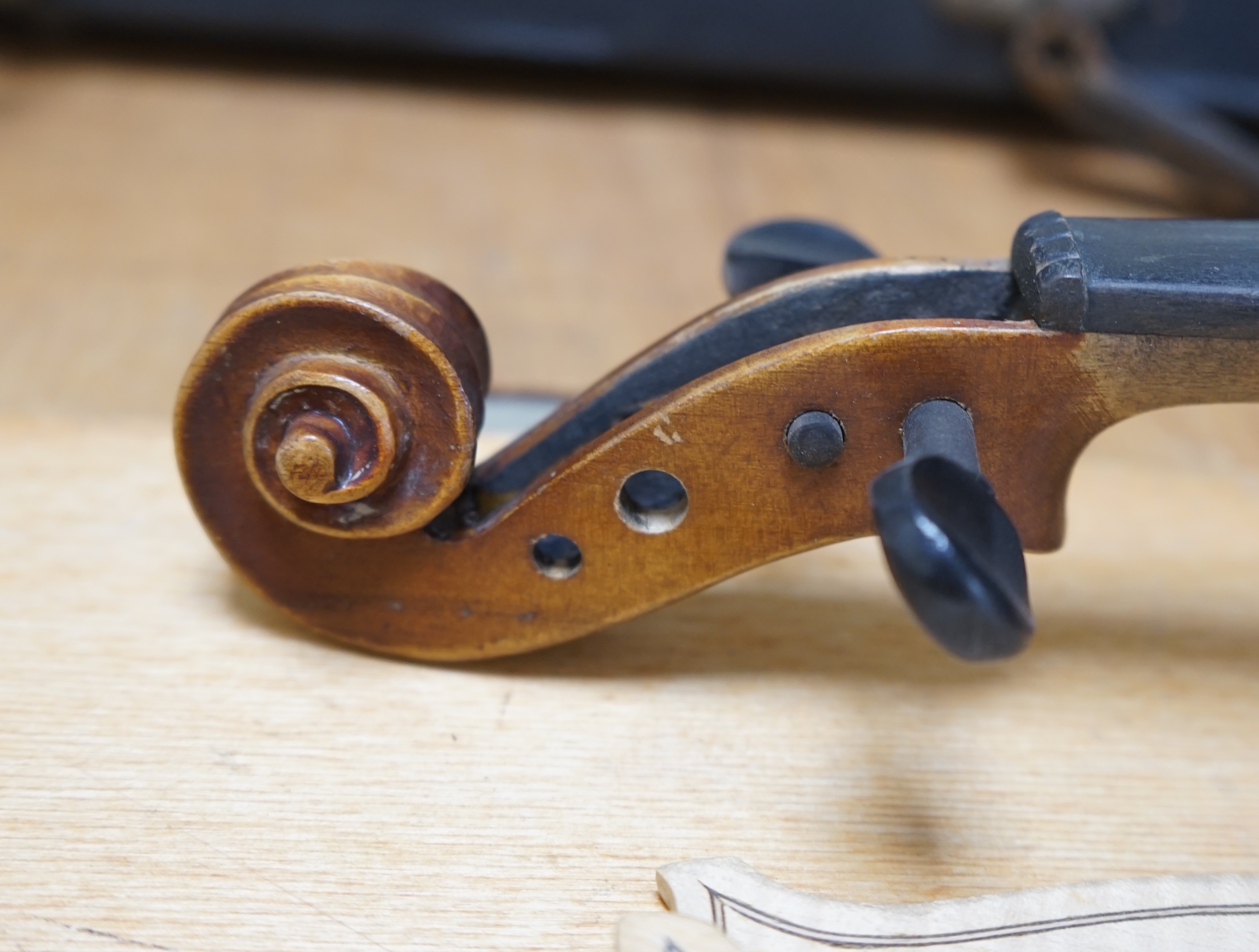 Early 20th century ¾ size violin, unlabelled, cased, together with a violin table, back and scroll. Condition - fair